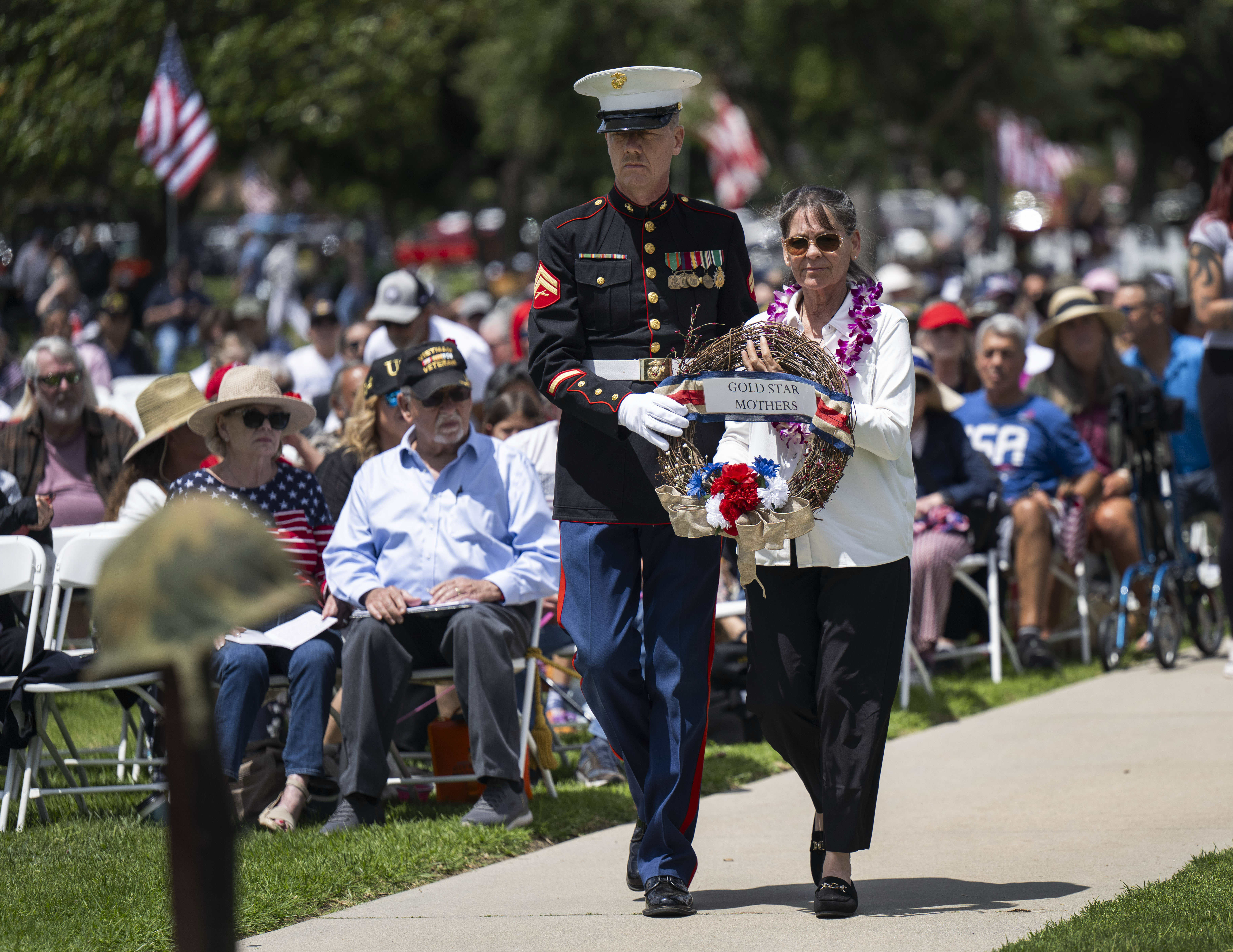 Gold Star mother Maria Simpson is accompanied by Marine Corps...