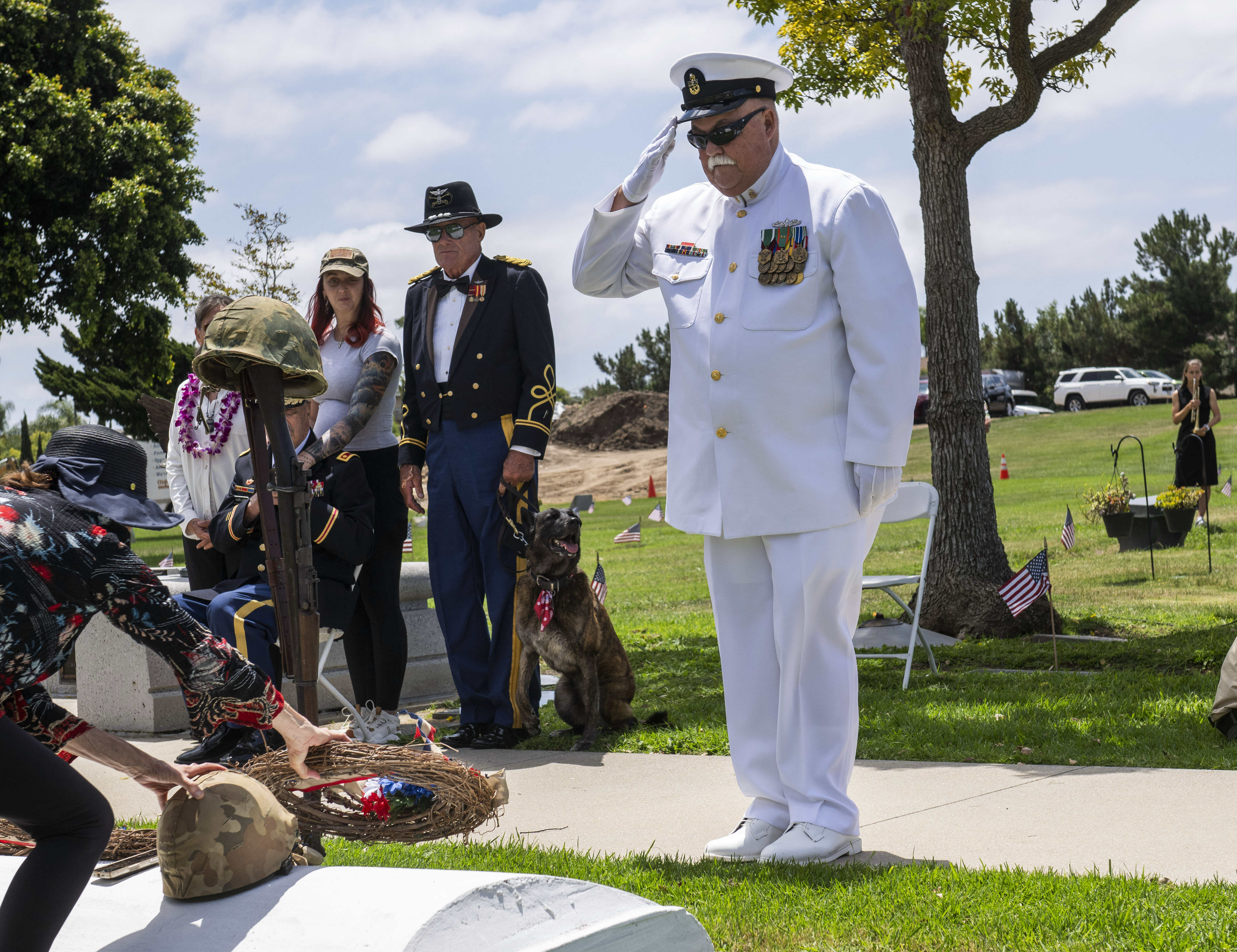 Navy veteran Gary Tegel gives a salute after laying the...
