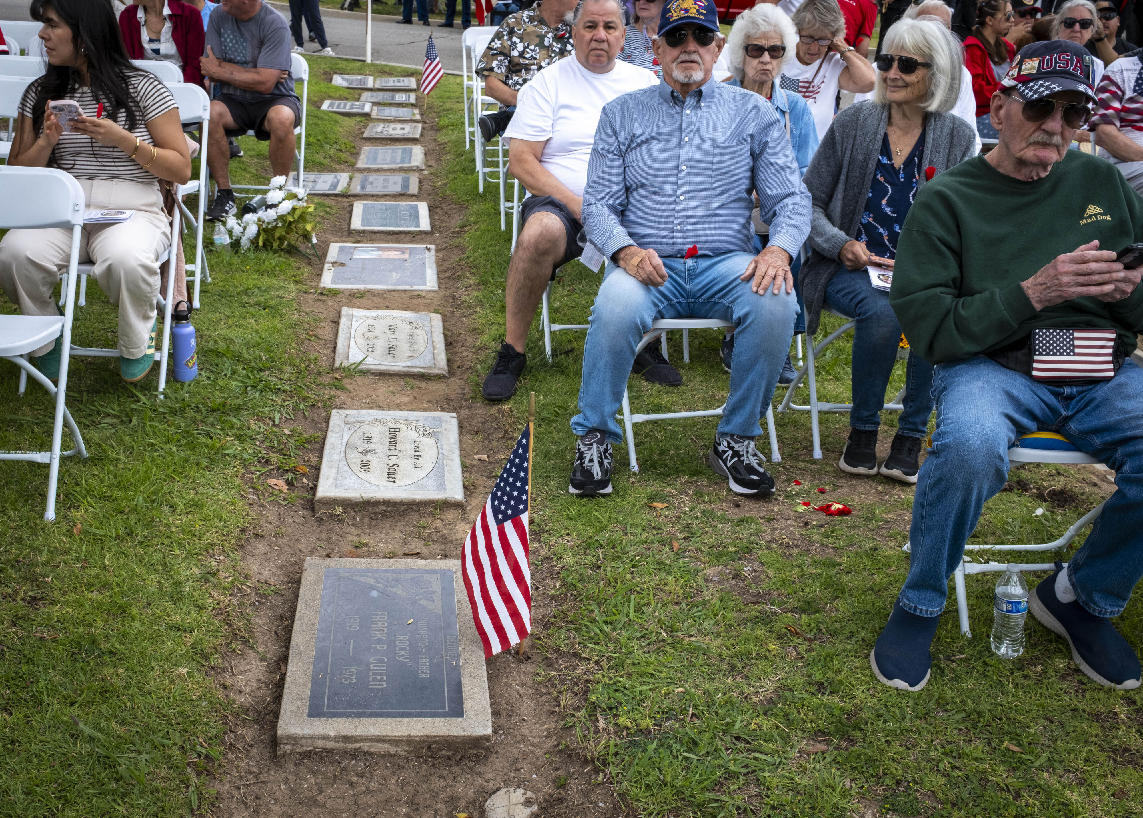 The grave of veteran Frank Culen joins the audience during...