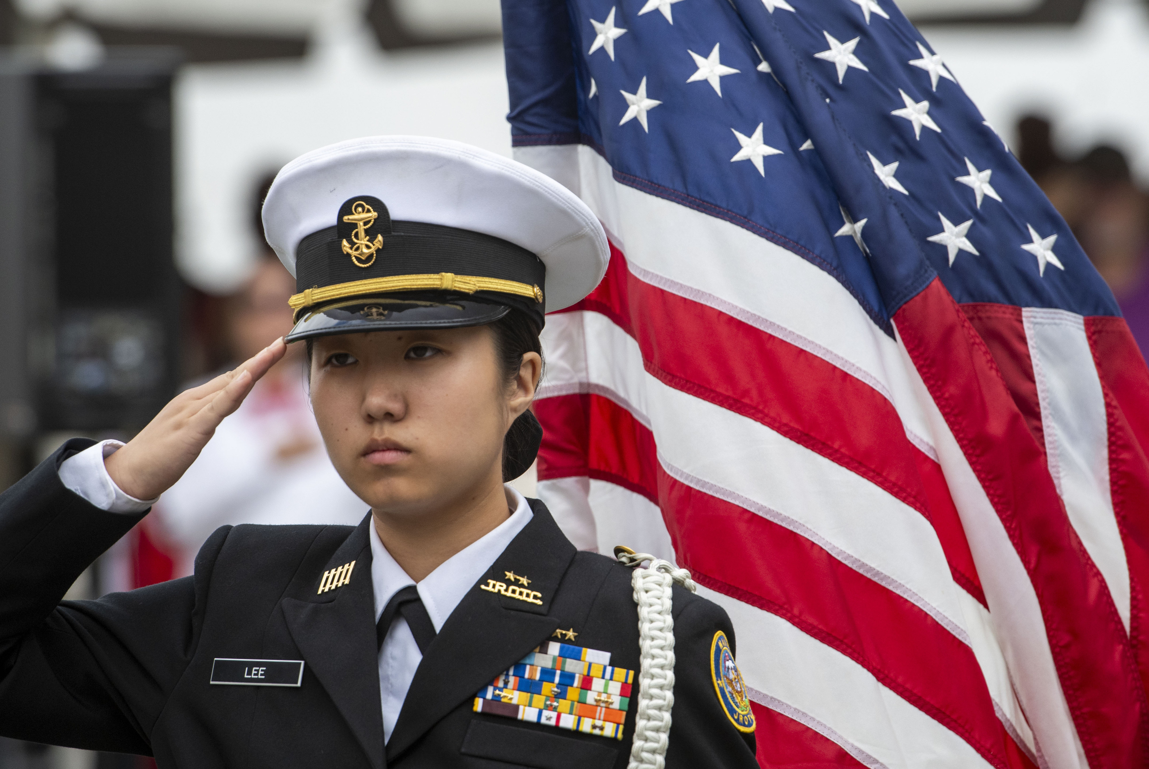 ROTC member Haying Lee of Troy High salutes during the...
