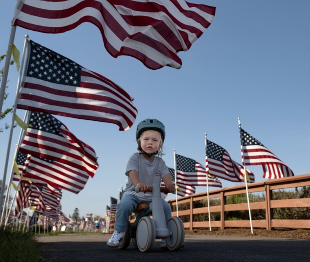 One-year-old Jack Kelley checks out the annual Field of Honor with his parents, Emily and Scott Kelley, in Newport Beach on Tuesday, May 19, 2026. The seemingly endless display of flags, honoring those who served, will be on display through Memorial Day. (Photo by Mindy Schauer, Orange County Register/SCNG)