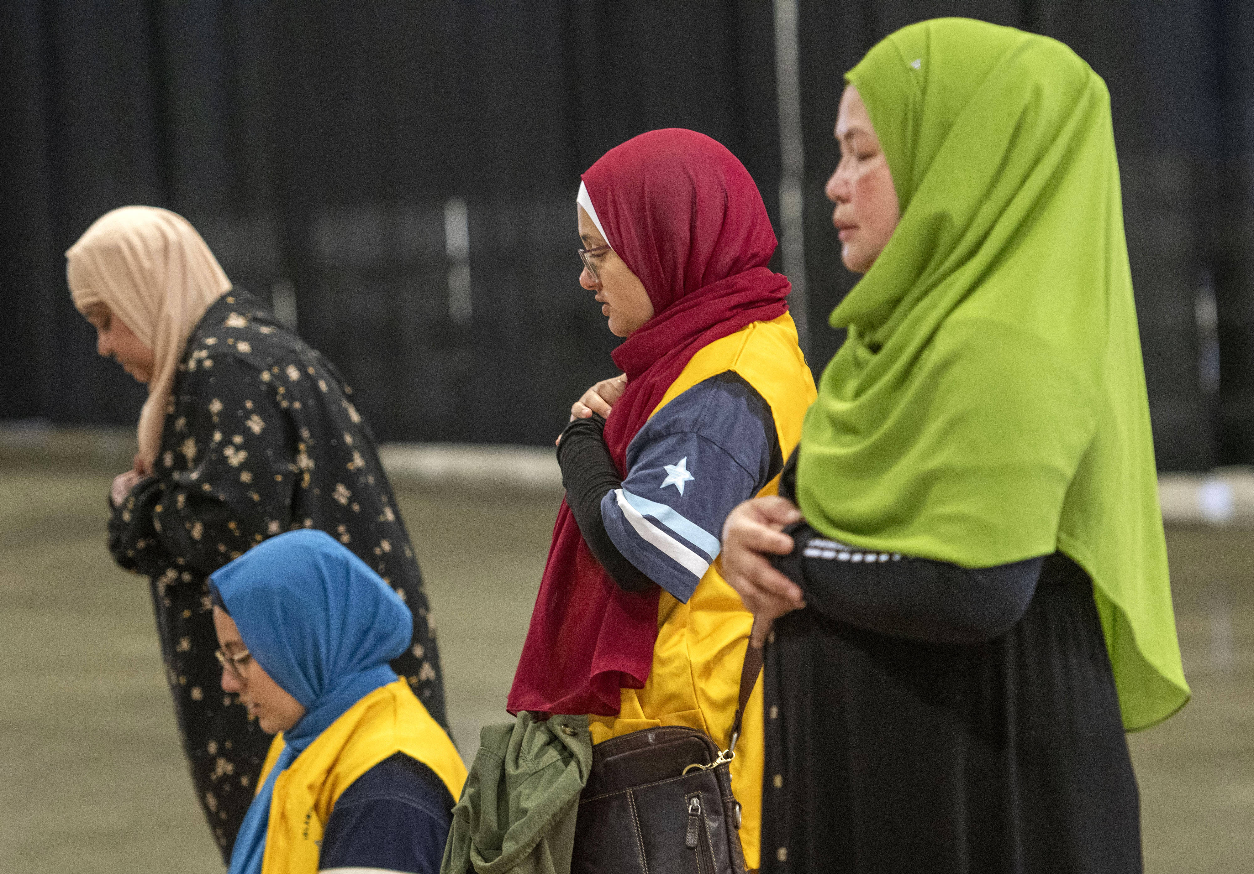 Women pray during the celebration of the Muslim holiday Eid...