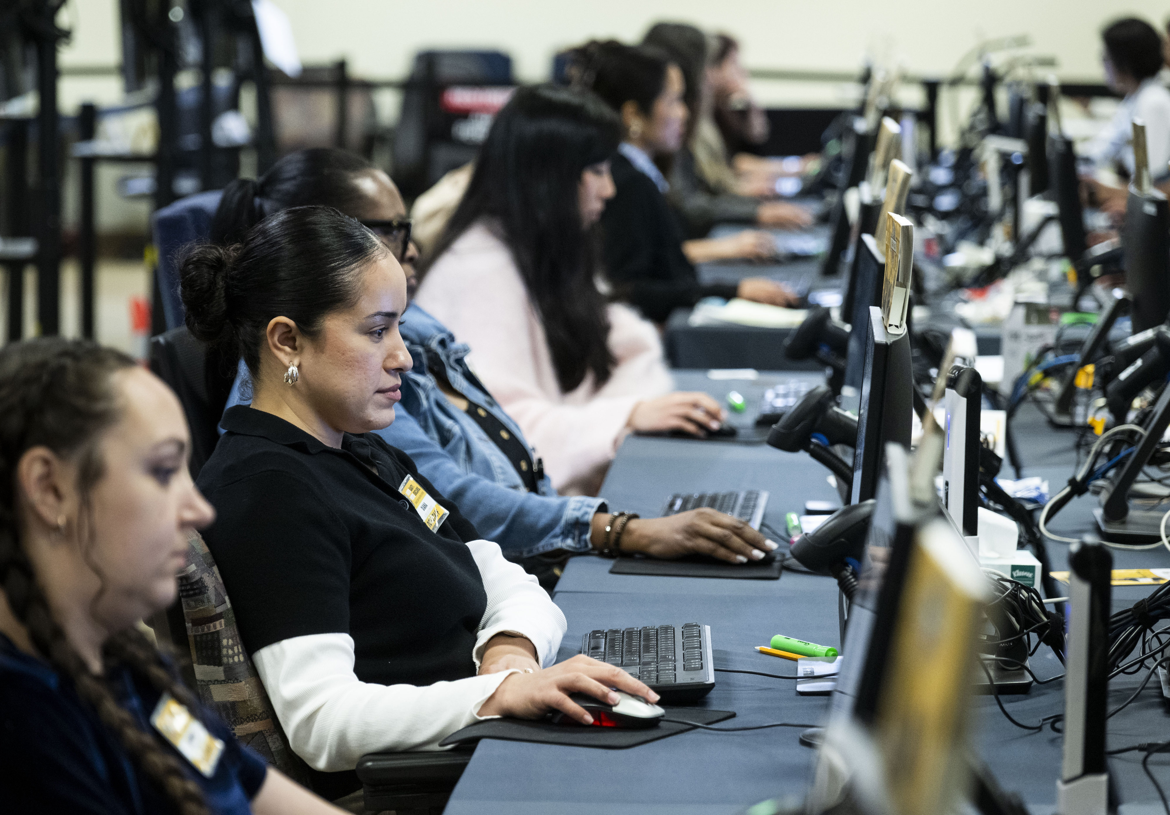 People work in signature verification at the Orange County Registrar...