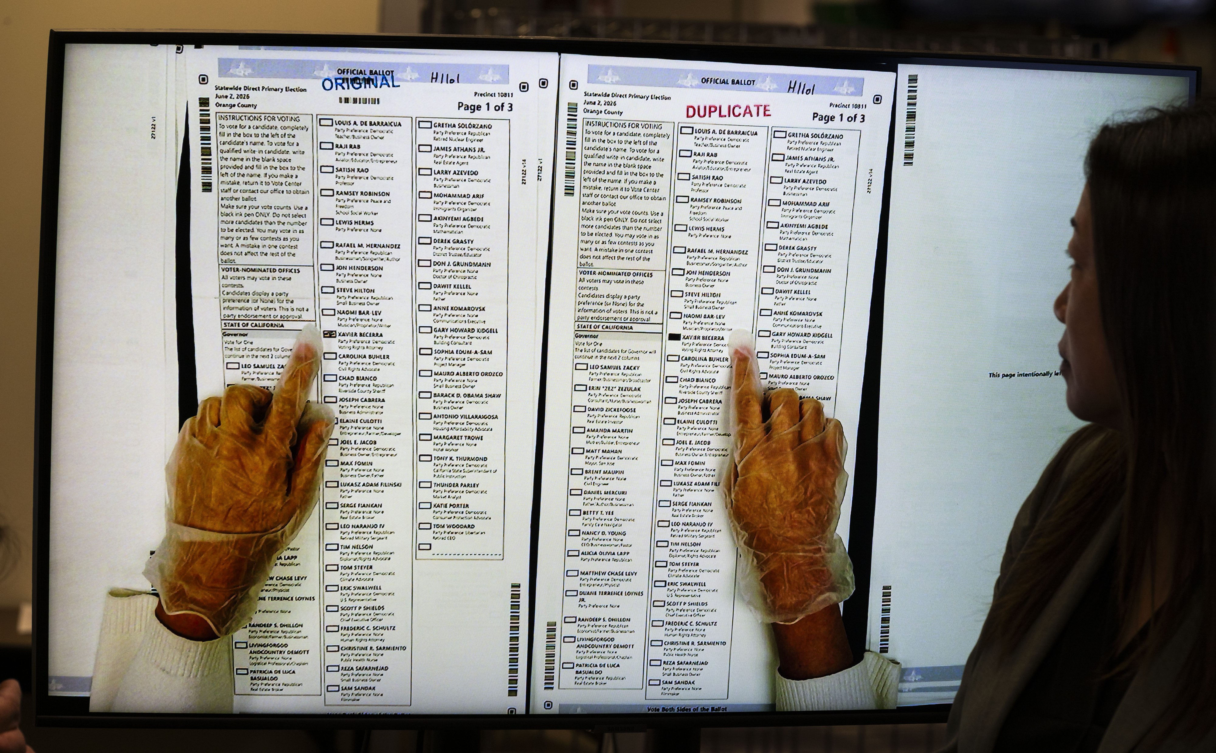 People work in ballot duplication at the Orange County Registrar...