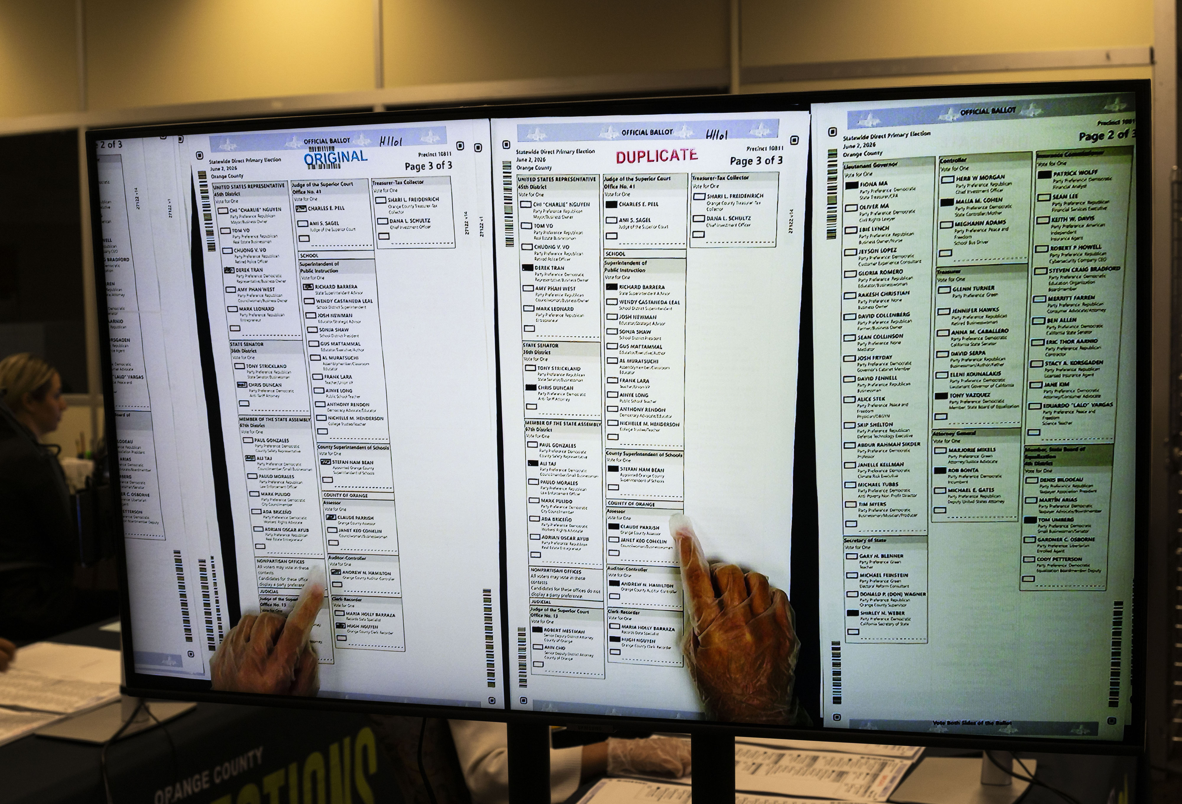People work in ballot duplication at the Orange County Registrar...