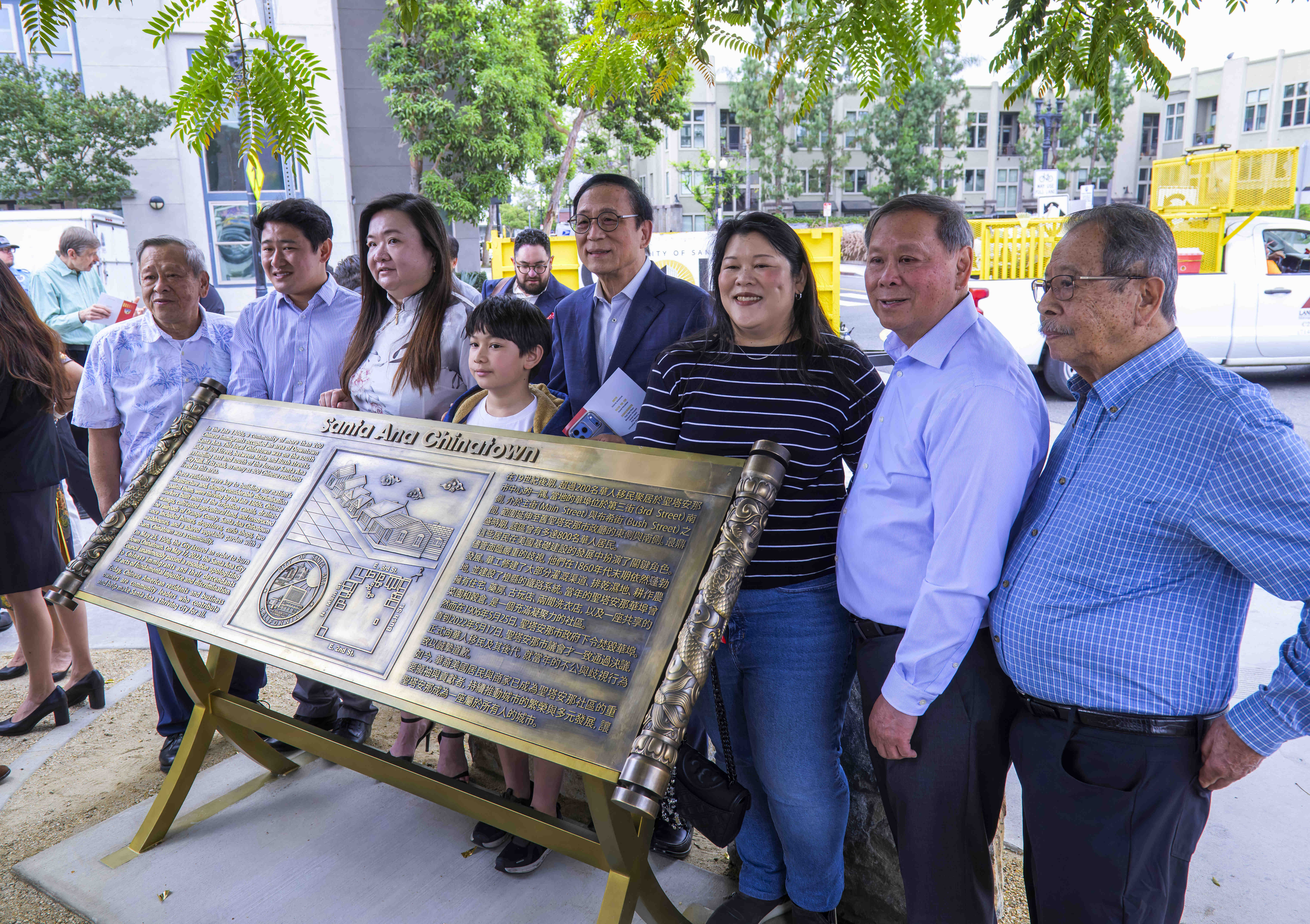 Members of the Lau family gather for a photo around...