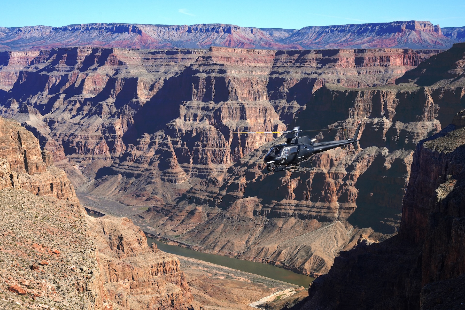 A helicopter films a scene in the Grand Canyon for...