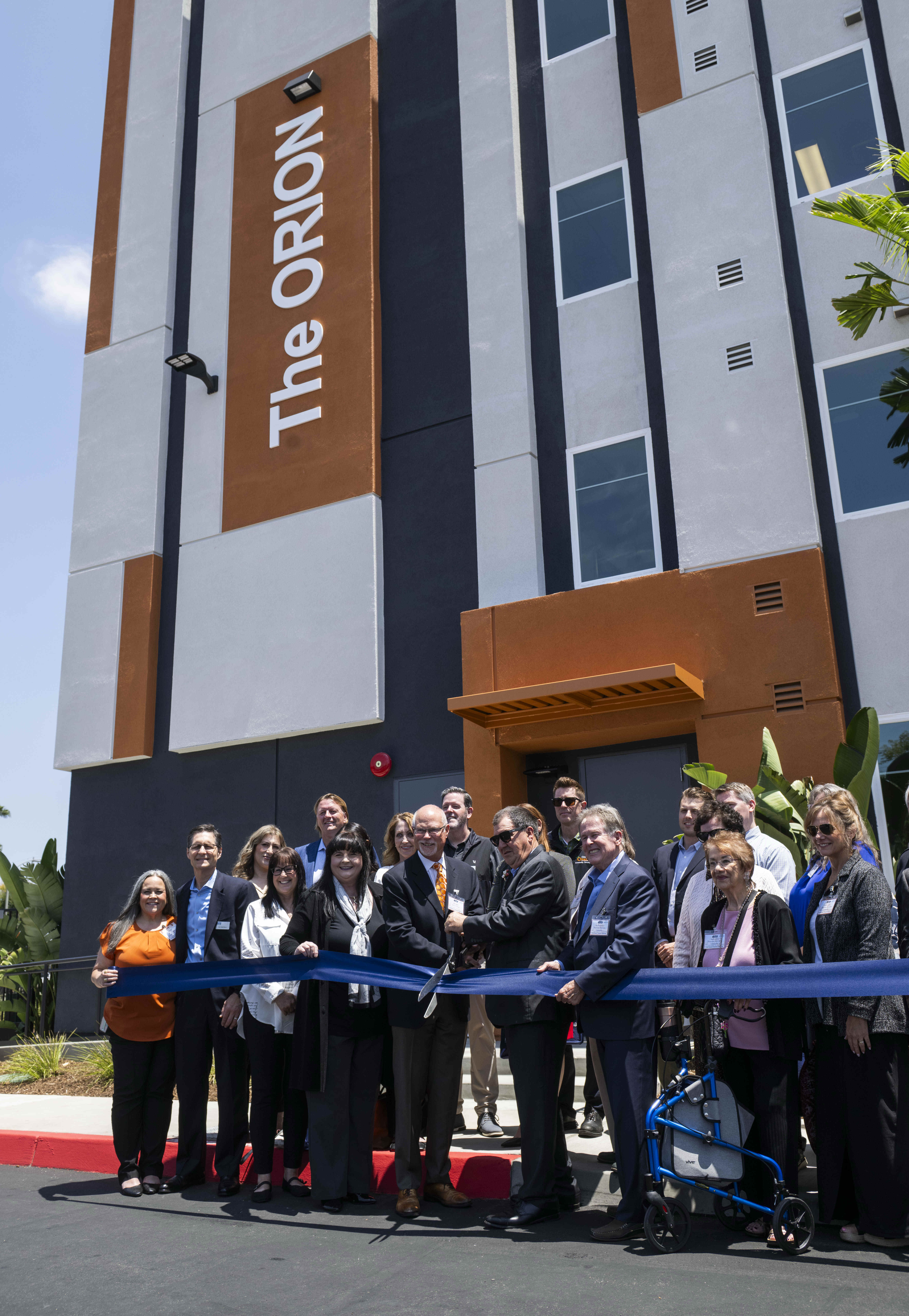 Orange Mayor Dan Slater, center left, cuts the ribbon with...