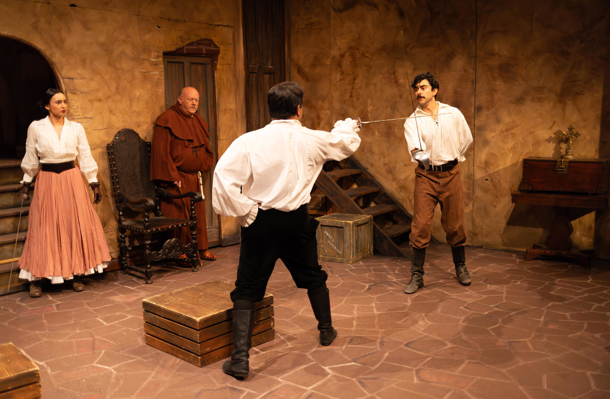 Felina (Alexandra Young) and Father Felipe (KC Mercer) watch Don...