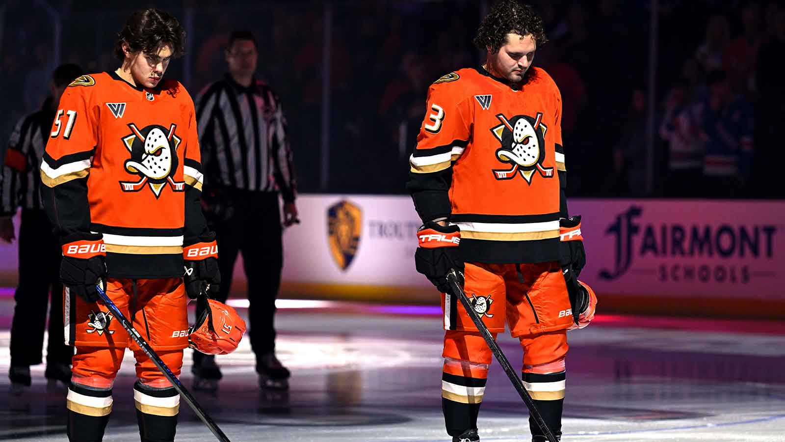 Anaheim Ducks defenseman Olen Zellweger (51) and Anaheim Ducks center Mason McTavish (23) line up during the national anthem before the game against the Toronto Maple Leafs at Honda Center.