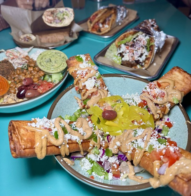 Doquitos are co-owner's Aiden Brennan-Law's favorite Spitz dish. Often described as a "Mediterranean twist on a taquito," doquitos consist of lavash bread rolled with zesty feta, onion, garlic aioli and a choice of meat which is fried, and then served with more toppings. (Courtesy of Spitz Mediterranean)