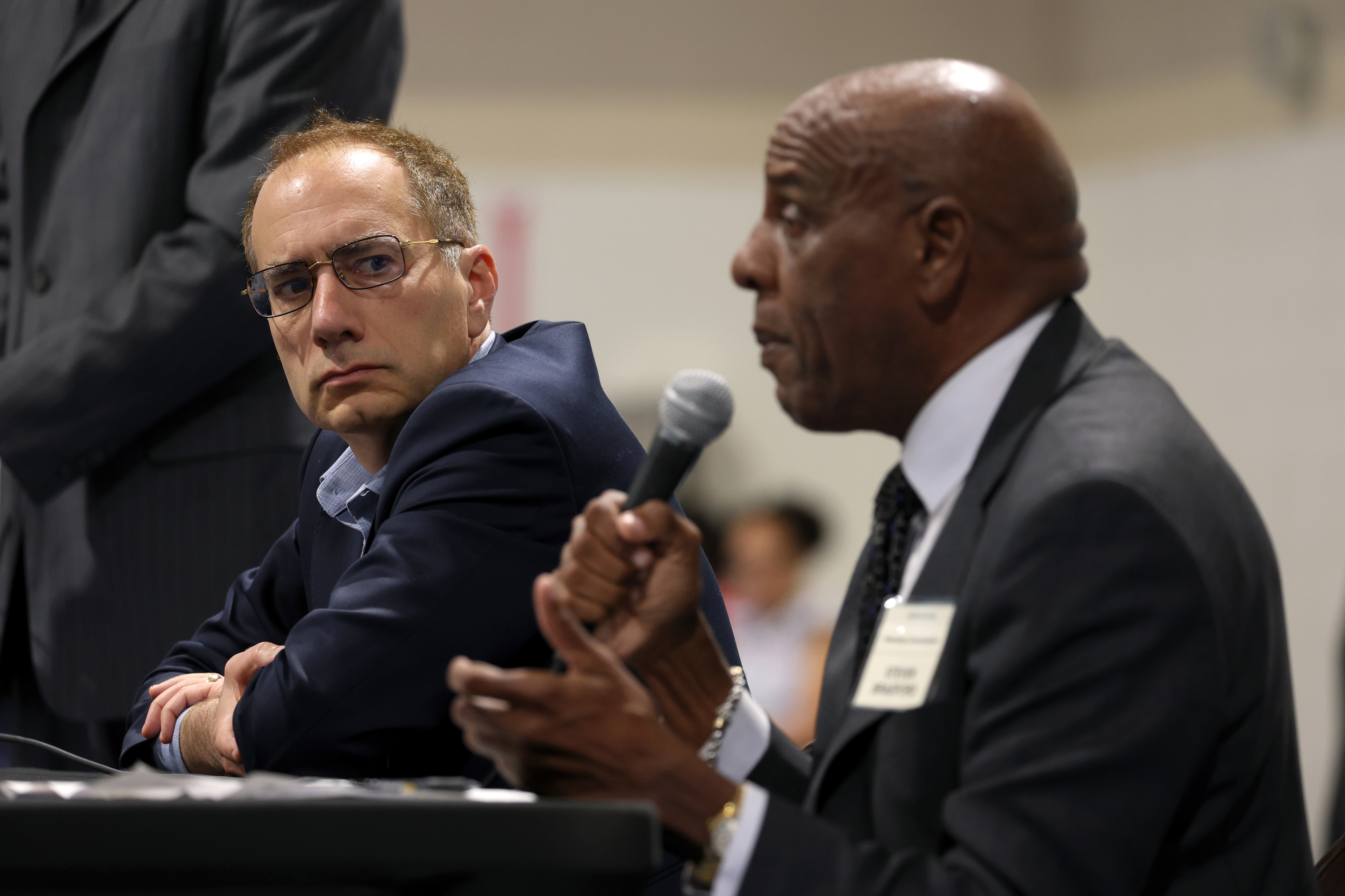 California Insurance Commissioner candidate Patrick Wolff looks on as fellow...