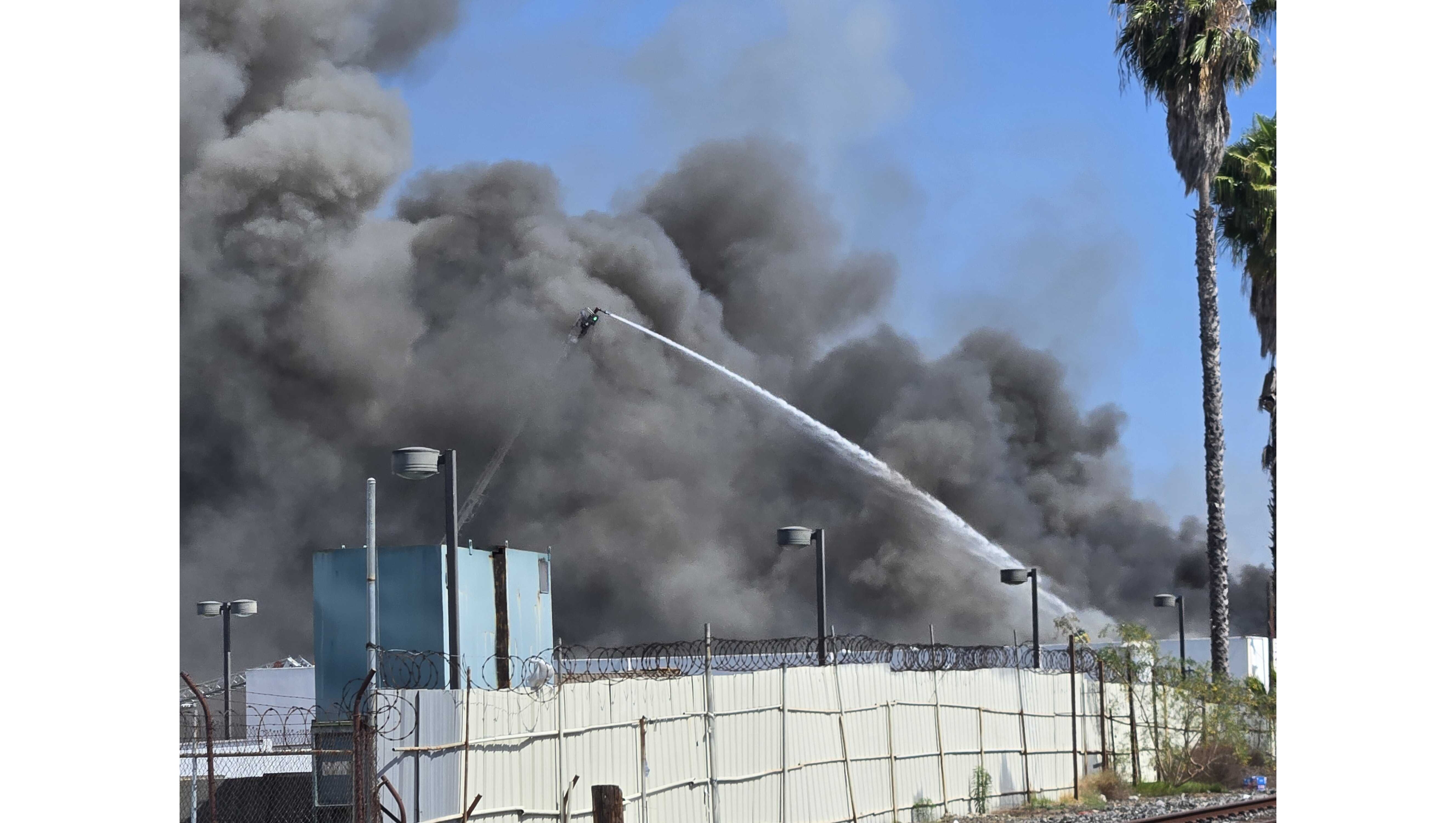 Firefighters battled an industrial building fire Sunday, May 24, in...