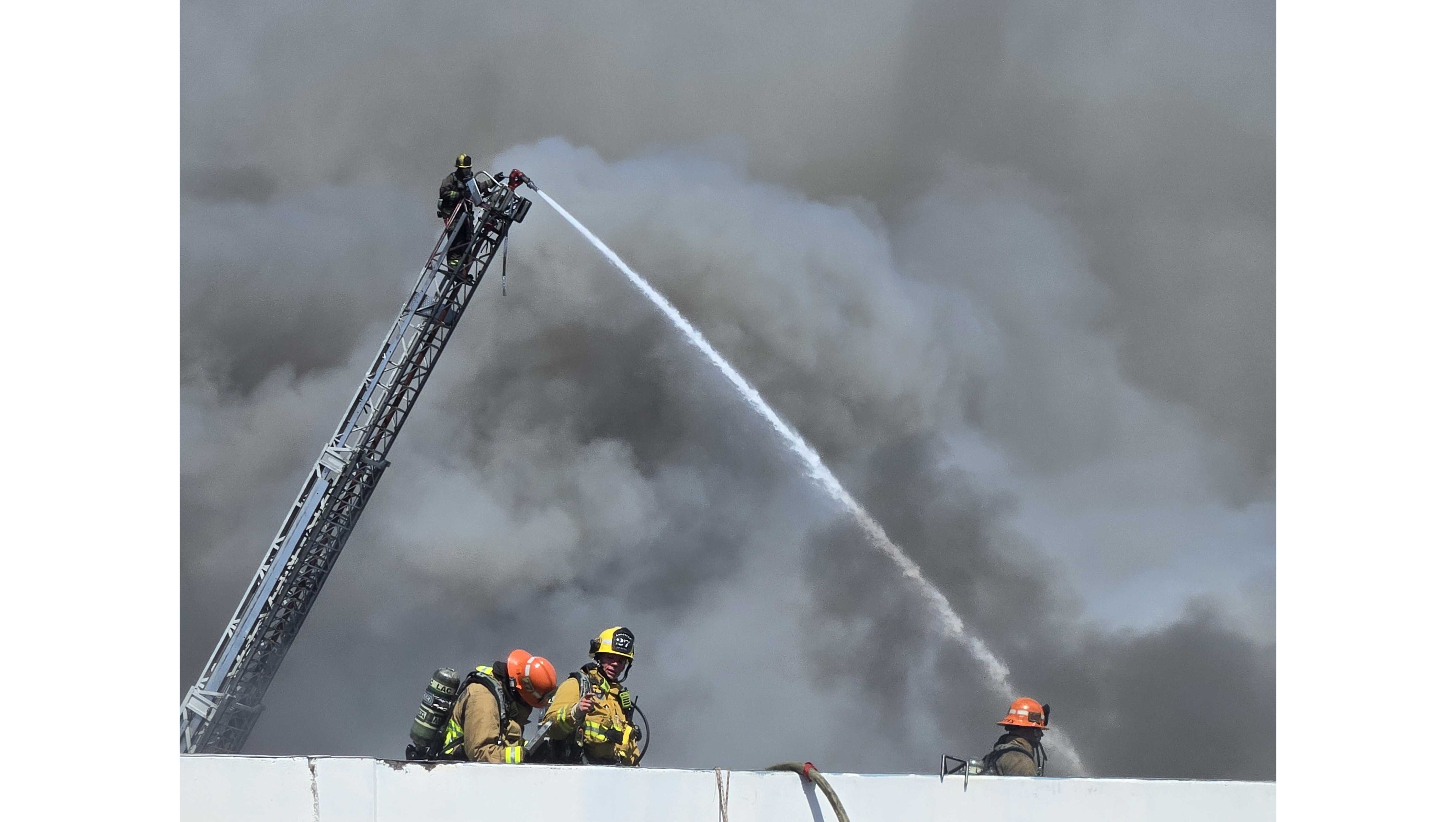 Firefighters battled an industrial building fire Sunday, May 24, in...