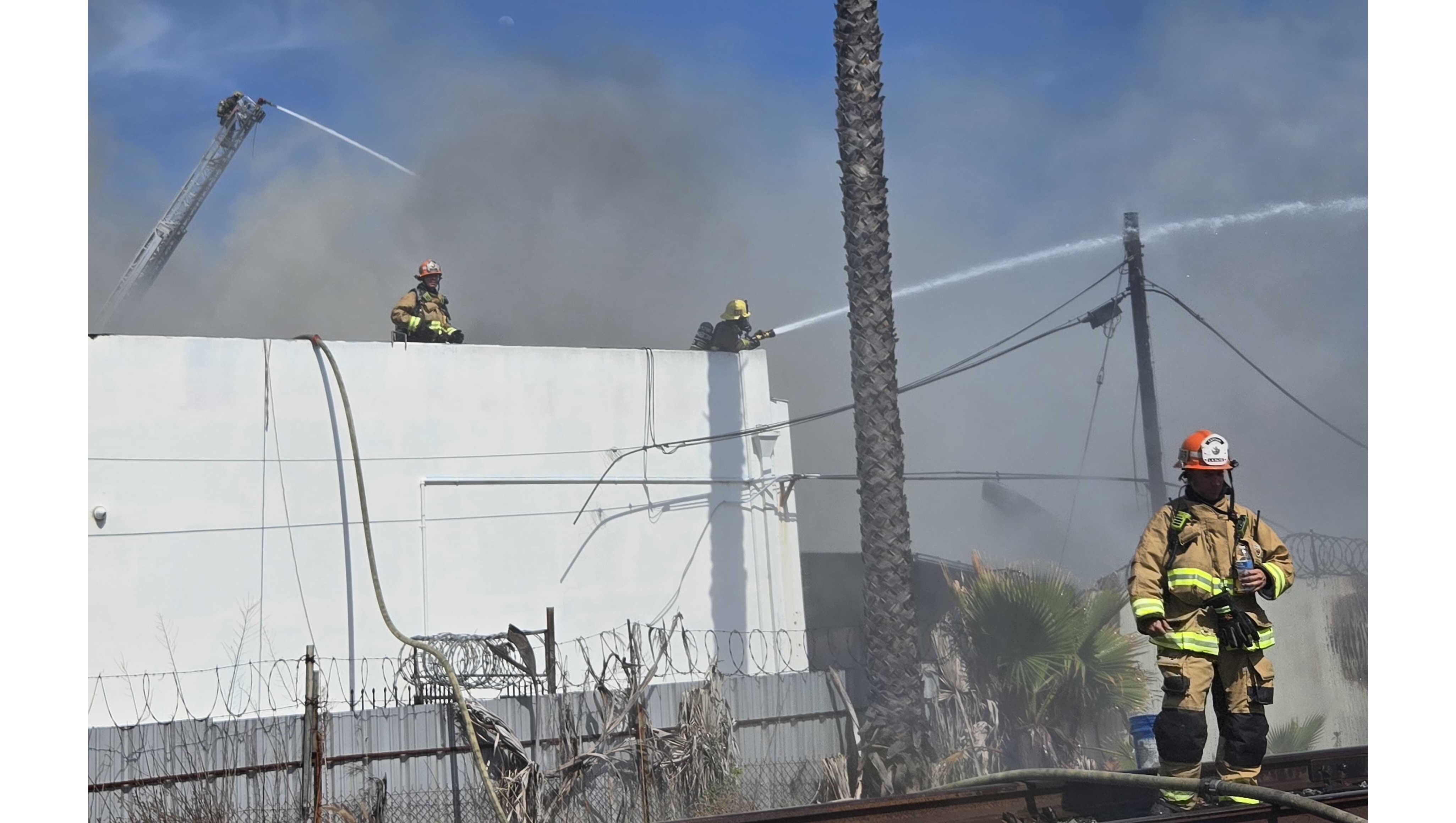 Firefighters battled an industrial building fire Sunday, May 24, in...