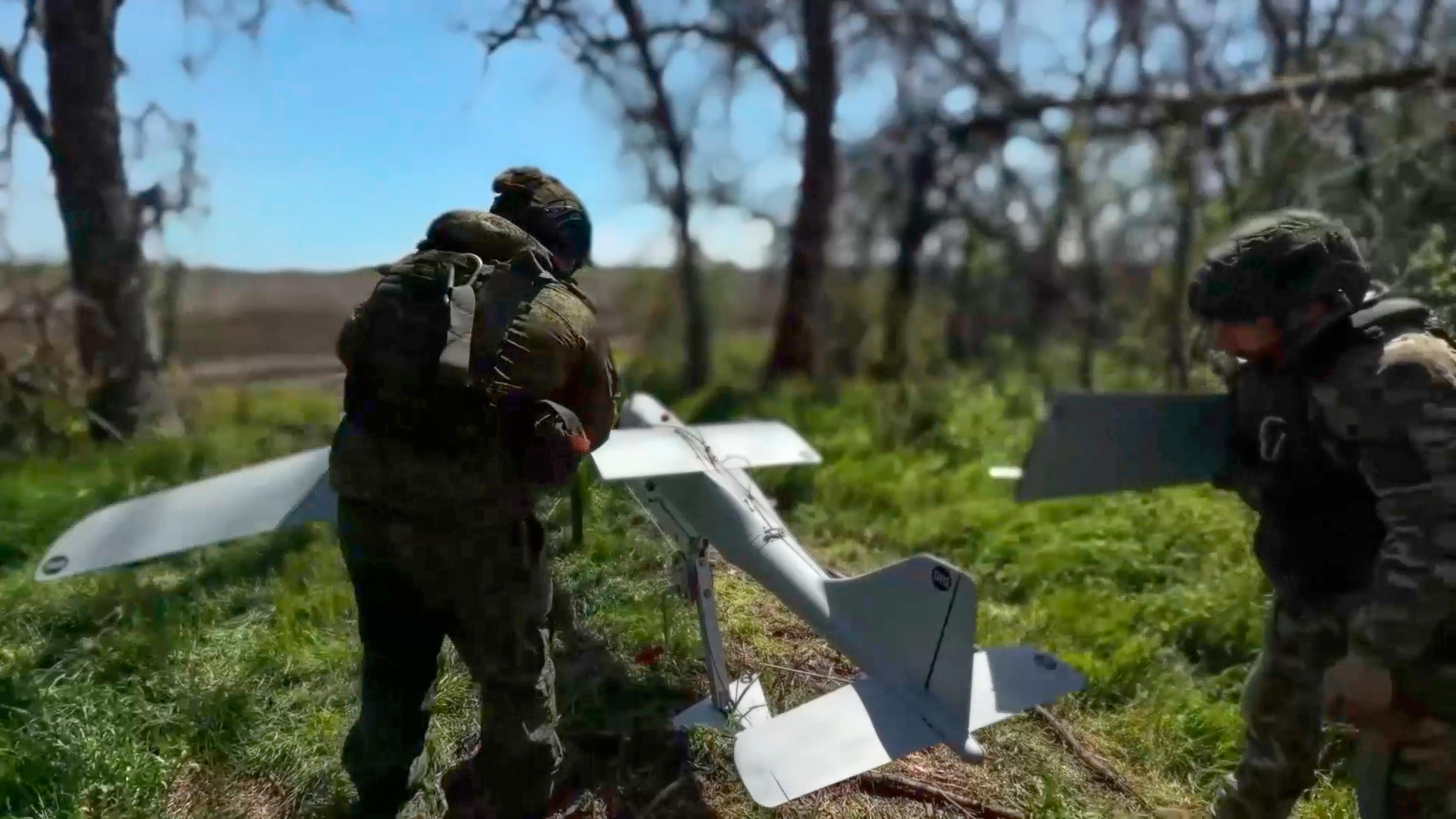 Russian servicemen prepare to launch an interceptor drone in Ukraine.