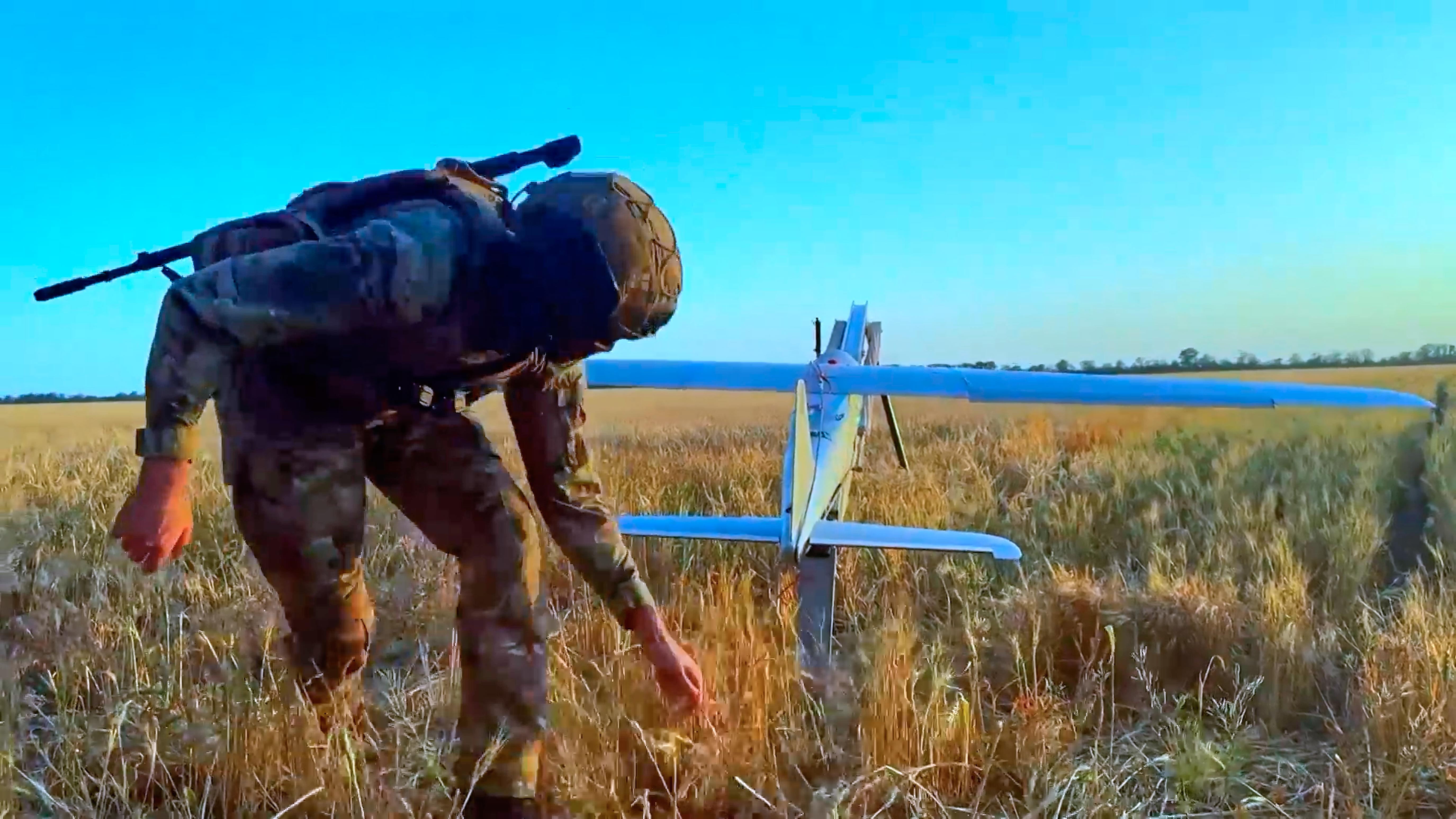 A Russian serviceman launches a drone in Ukraine.