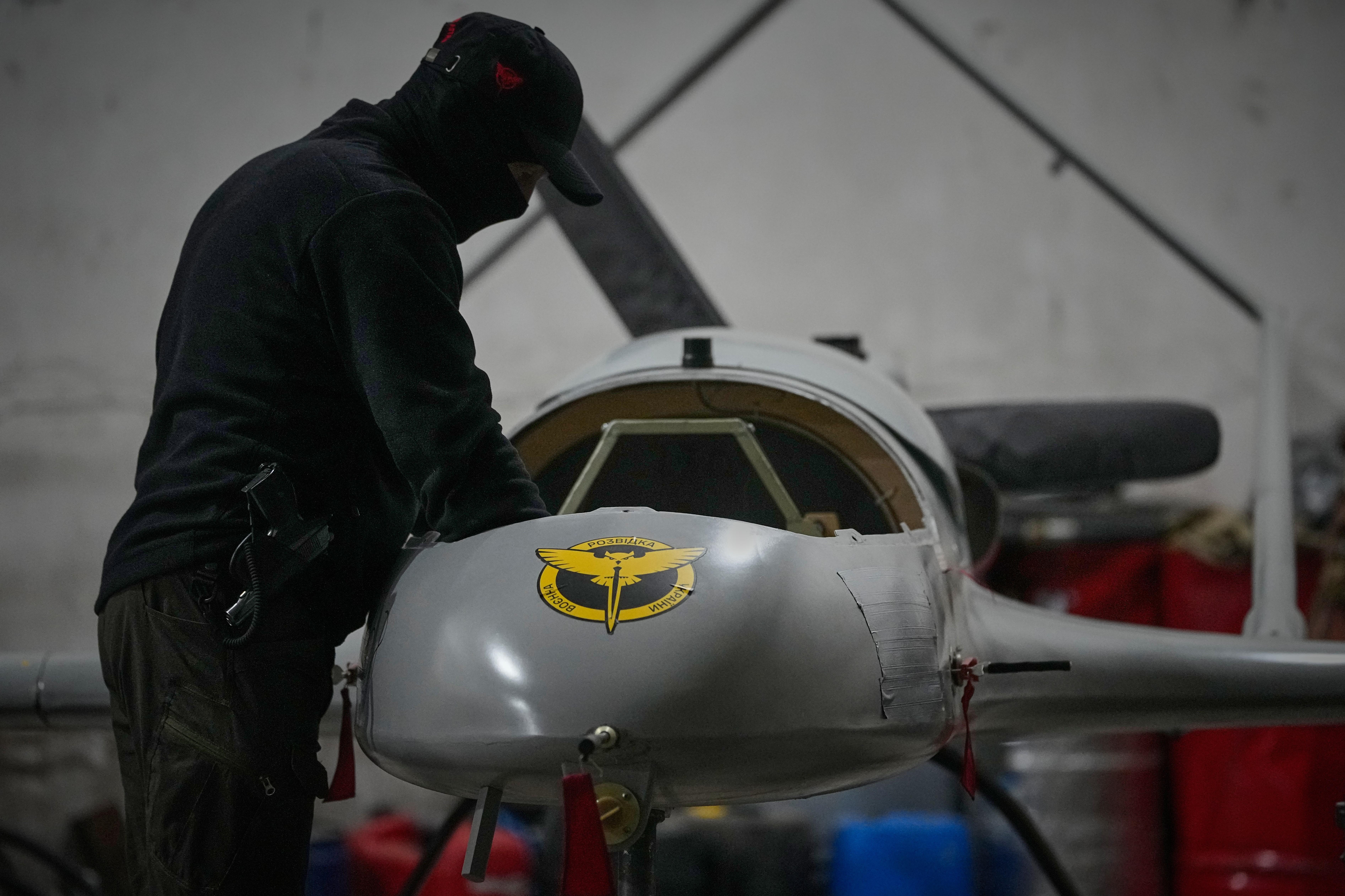 A serviceman of Ukraine's Defence Intelligence prepares an An-196 Liutyi drone.