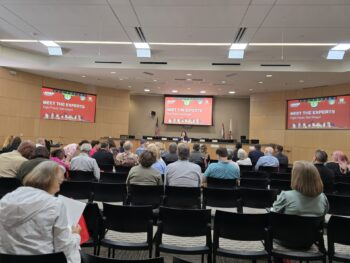 People in conference room listening to speaker