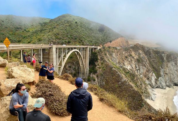 Tourists enjoy the view of the Bixby Creek Bridge, on the Big Sur coast of California, on Aug. 1, 2020. (Photo by DANIEL SLIM/AFP via Getty Images)