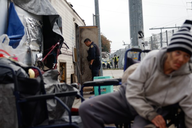 A San Jose Police officer looks inside a trailer that is prepared to be towed in San Jose, Calif., on Wednesday, Dec. 10, 2025. (Shae Hammond/Bay Area News Group)