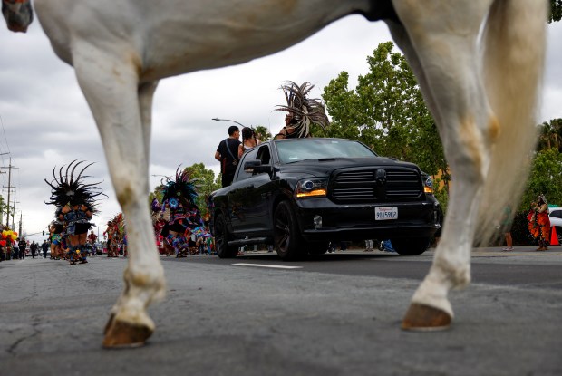 Dancers head south down South King Road in a vintage police car during the 3rd Annual San Jose Cinco de Mayo Cultural Parade & Festival in San Jose, Calif., on Sunday, May 3, 2026. (Nhat V. Meyer/Bay Area News Group)