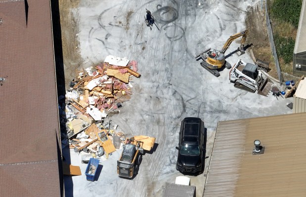 A compact track loader piles debris outside of a building in a drone view of a potential U.S. Immigration and Customs Enforcement detention center in Gilroy, Calif., on Thursday, May 14, 2026. (Nhat V. Meyer/Bay Area News Group)