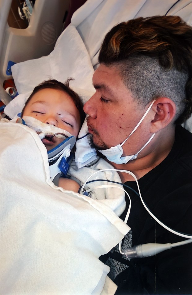 Albert Juarez with his son Jaxon in a hospital days before his death. (Photo courtesy of Juarez Family)