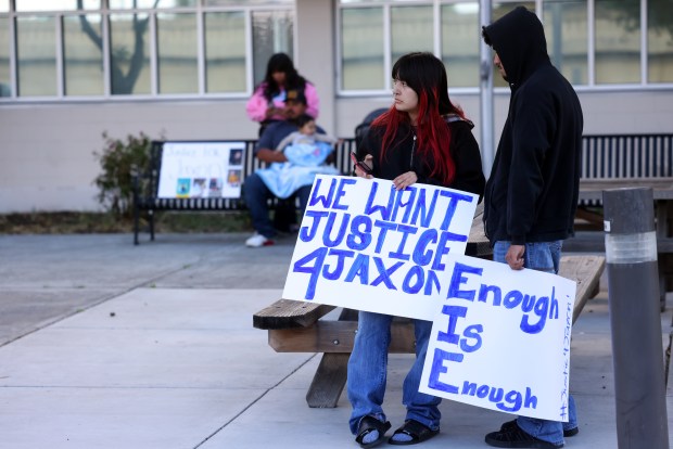 Community members hold signs outside the Santa Clara County Juvenile Justice Courthouse on Monday, April 20, 2026, in San Jose, Calif. The San Jose teenager accused of sexually assaulting his 2-year-old cousin before the toddler died has been charged with murder and county prosecutors will also seek to move the charges to adult court as the teen suspect just turned 18. (Aric Crabb/Bay Area News Group)
