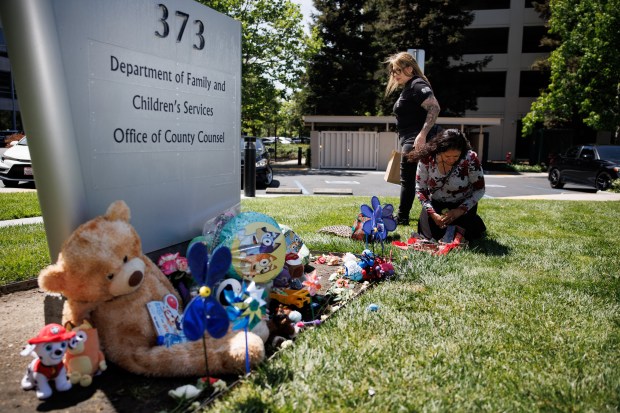 Stuffed animals and flowers are visible at a memorial for two-year-old Jaxon Rey Juarez in front of the Department of Family and Children's Services building in San Jose, Calif., on April 24, 2026. Juarez died April 9 after being placed in the foster home of relatives. (Dai Sugano/Bay Area News Group)