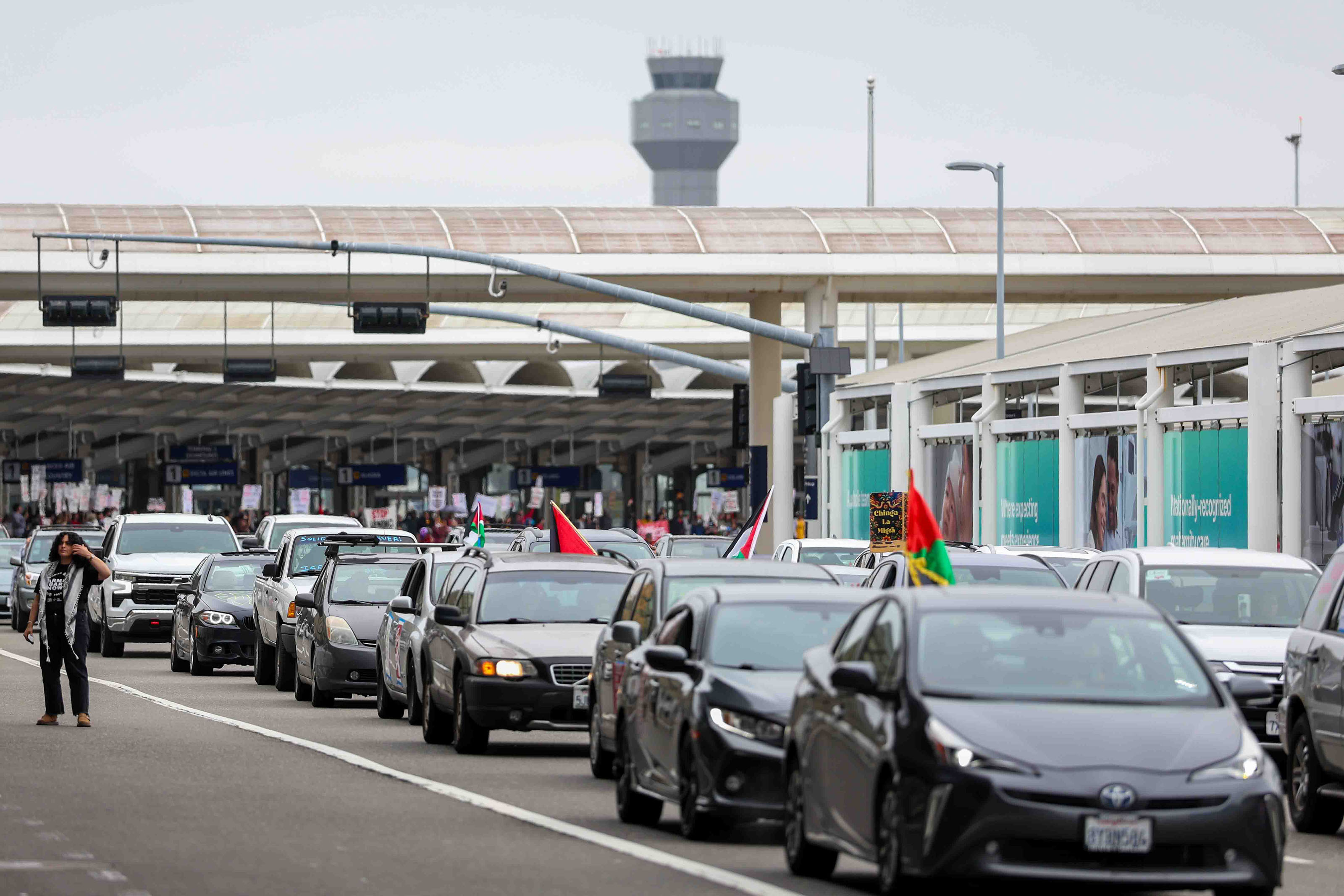 Demonstrators riding in a caravan protest at Oakland International Airport...