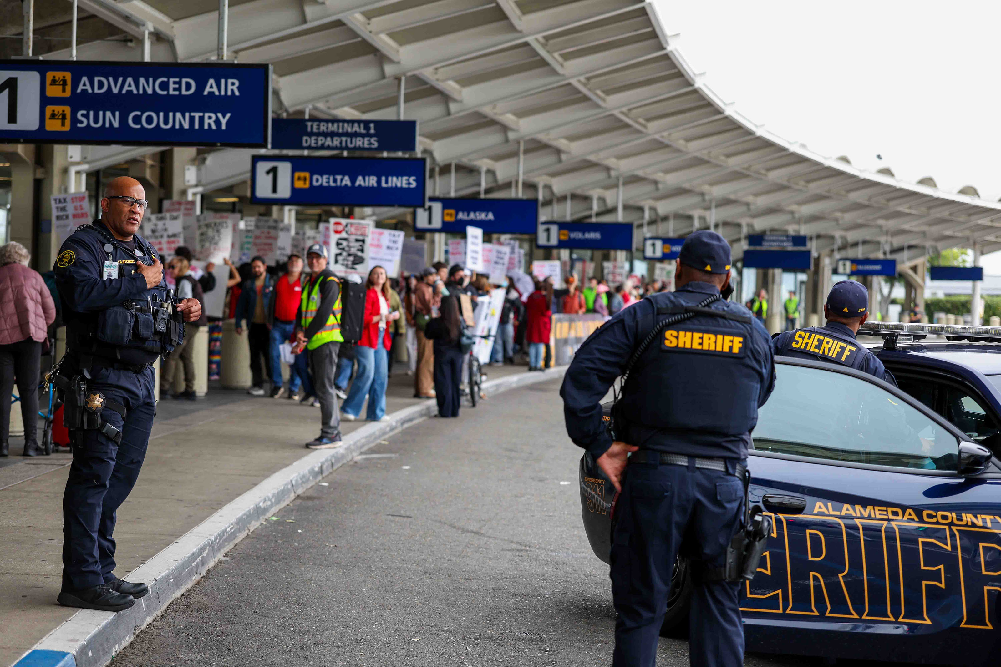 Alameda County sheriff's officers stand guard as demonstrators protest at...