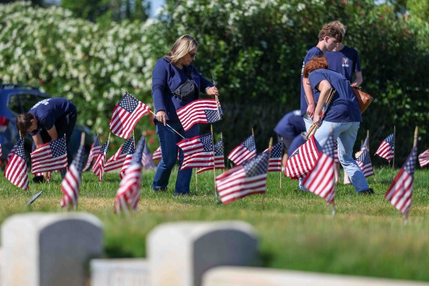 About 120 mother-and-son teams from the Livermore chapter of the Young Men's Service League, in partnership with members of American Legion Post 47, place American flags in front of the gravestones of fallen soldiers for Memorial Day weekend at Memory Garden Cemetery in Livermore, Calif., Saturday, May 23, 2026. (Ray Chavez/Bay Area News Group)