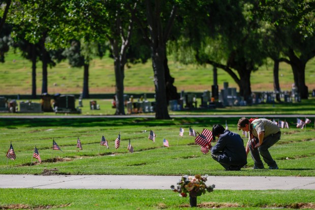 Boy Scouts place flags at the gravesites of people who served in the US Arm Forces at Oak Hill Cemetary in San Jose, Calif., on Saturday, May 23, 2026. (Shae Hammond/Bay Area News Group)