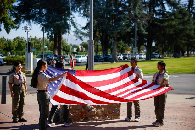 Boy Scouts hold a Flag ceremony before placing flags at the gravesites of people who served in the US Arm Forces at Oak Hill Cemetary in San Jose, Calif., on Saturday, May 23, 2026. (Shae Hammond/Bay Area News Group)