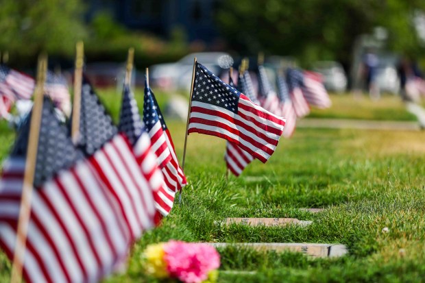 American flags stand in front of the gravestones of fallen soldiers for Memorial Day weekend at Memory Garden Cemetery in Livermore, Calif., Saturday, May 23, 2026. About 120 mother-and-son teams from the Livermore chapter of the Young Men's Service League, in partnership with members of American Legion Post 47, placed the flags during the annual event at Memory Garden Cemetery and St. Michael's Cemetery. (Ray Chavez/Bay Area News Group)
