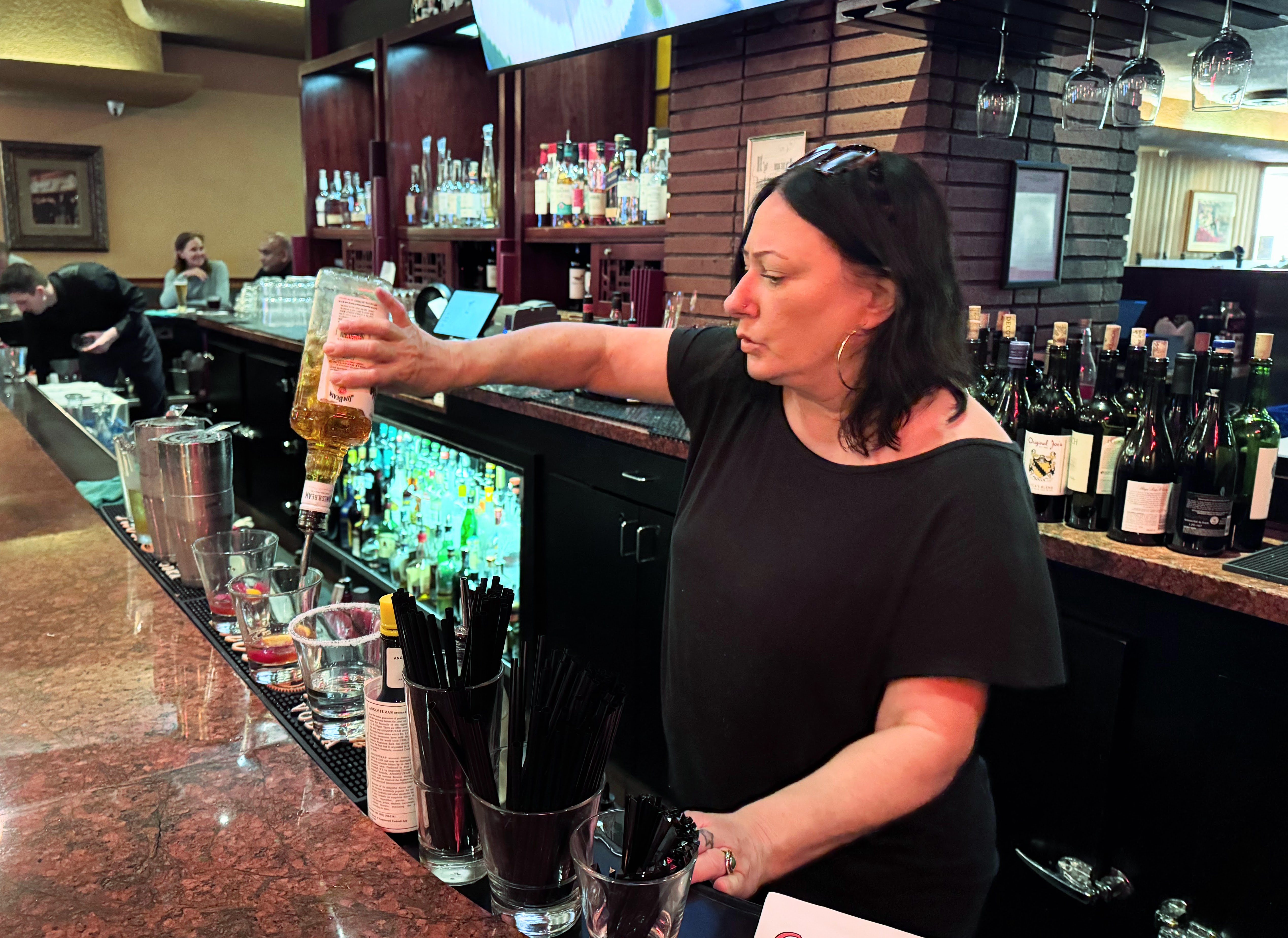 Bartender Aryn Miller pours a drink at Original Joe’s on...