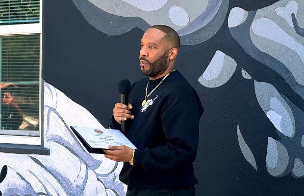 Artist Ian Young talks about a new mural he painted at the African American Community Service Agency honoring Inez Jackson, the first Black postal worker in San Jose, on Saturday, May 16, 2026. (Sal Pizarro/Bay Area News Group)