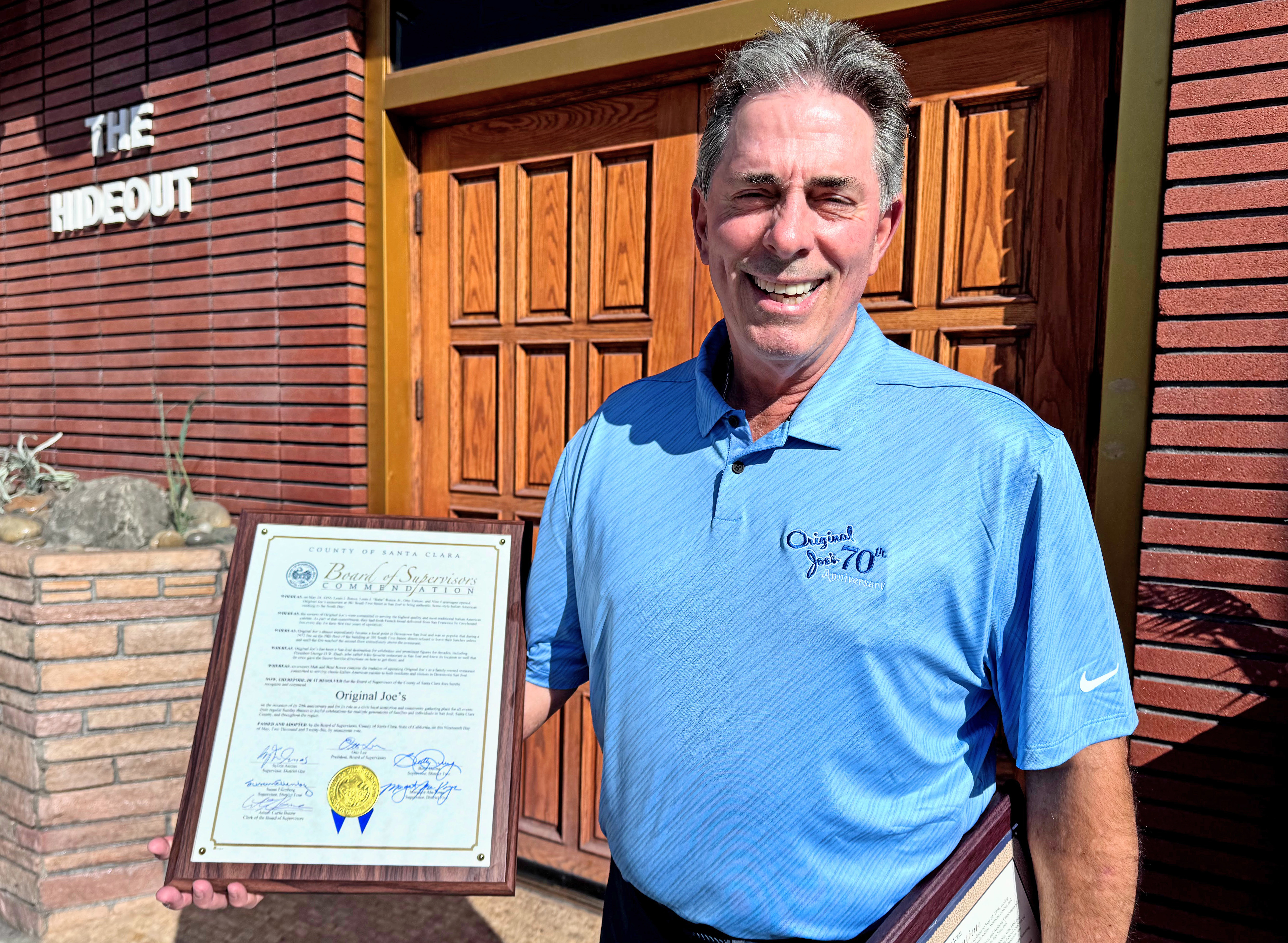 Original Joe's co-owner Brad Rocca holds a commendation from the...
