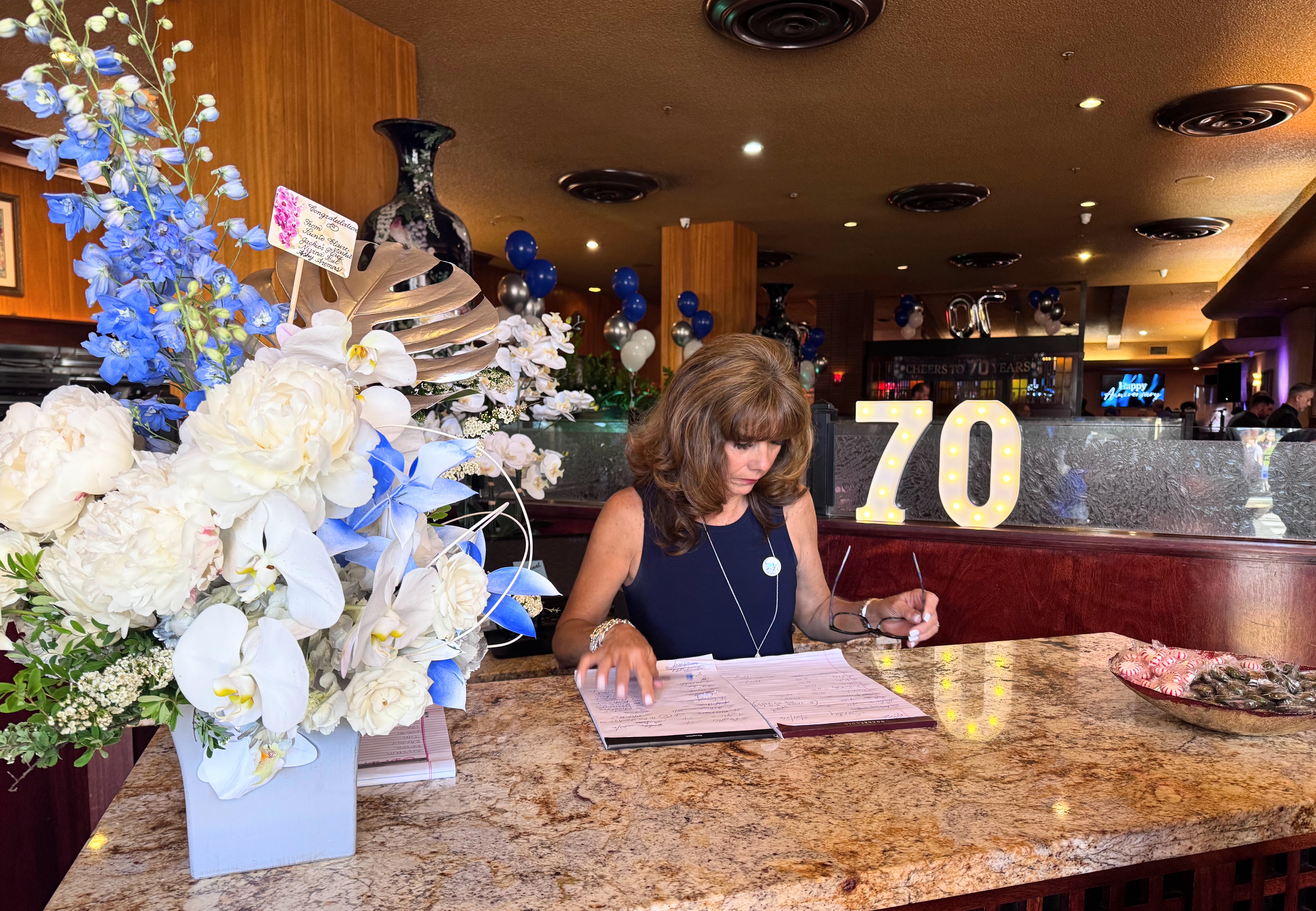 Michelle Rocca checks the waitlist on Original Joe's 70th anniversary...