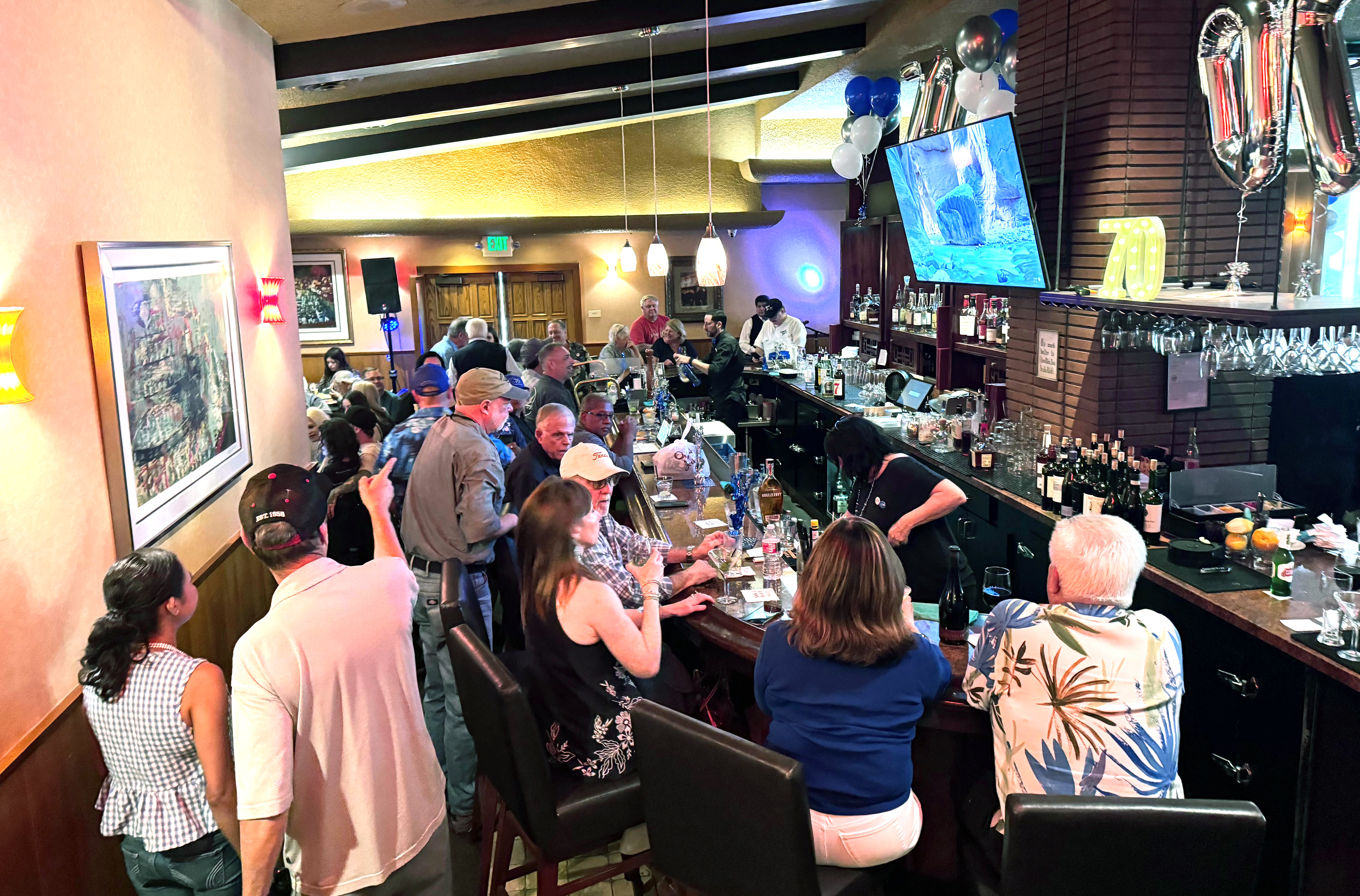 The lounge at Original Joe's is crowded with patrons celebrating...