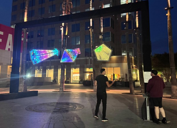 Two visitors to the Circle of Palms in downtown San Jose interact with "Gaiascope," an art installation by artist Brooke Einbender, on Wednesday, May 27, 2026. (Sal Pizarro/Bay Area News Group)