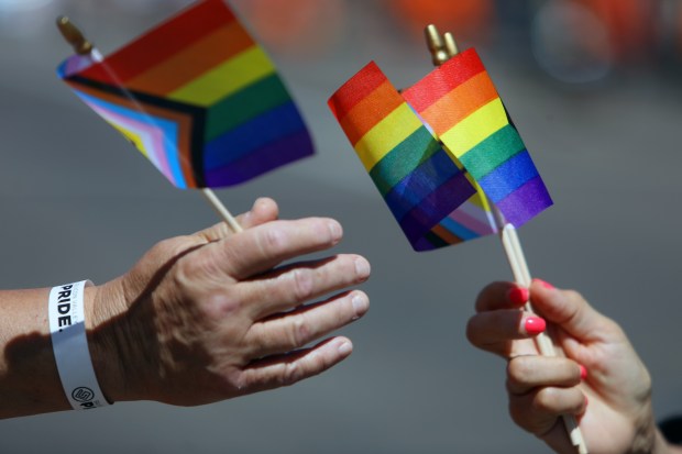 Rainbow flags are distributed along Market Street during the Silicon Valley Pride Parade on Sunday, Aug. 27, 2023, in San Jose, Calif. (Aric Crabb/Bay Area News Group)