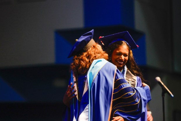 Sivagami Subramanyan, graduating with business honors, Cum Laude, hugs President of San Jose State University Dr. Cynthia Teniente-Matson during The Lucas College and Graduate School of Business graduation ceremony at SJSU in San Jose, Calif., on Thursday, May 21, 2026. (Shae Hammond/Bay Area News Group)