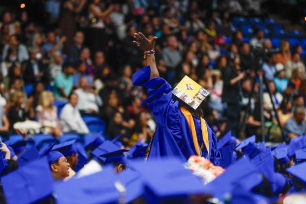 A graduate waves towards the crowd during The Lucas College and Graduate School of Business graduation ceremony at SJSU in San Jose, Calif., on Thursday, May 21, 2026. (Shae Hammond/Bay Area News Group)