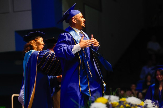 Makanel Dewill, graduating with business honors, walks across the stage during The Lucas College and Graduate School of Business graduation ceremony at SJSU in San Jose, Calif., on Thursday, May 21, 2026. (Shae Hammond/Bay Area News Group)