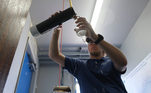 San Diego, CA_5_7_26_Brent Fish, an aquarist at Birch Aquarium at Scripps Institute, takes hold of a Niskin sampling bottle, left, used for taking sea water samples from just above the ocean bottom over Scripps Pier. He will then measure the temperature of the water and record it. A strong El Niño is affecting the water temperature of the Eastern Pacific. Photo by John Gastaldo for the Union-Tribune