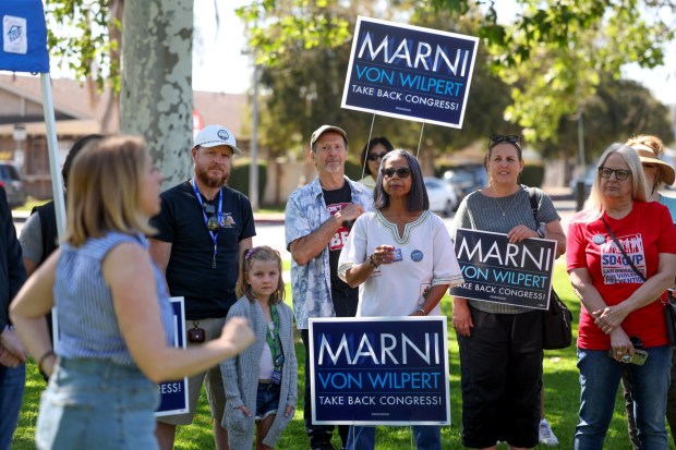 Campaign volunteers listen as Marni von Wilpert, left, speaks to them before they start canvassing for her at Washington Park in Escondido on Saturday, May 9, 2026. (Hayne Palmour IV / For The San Diego Union-Tribune)