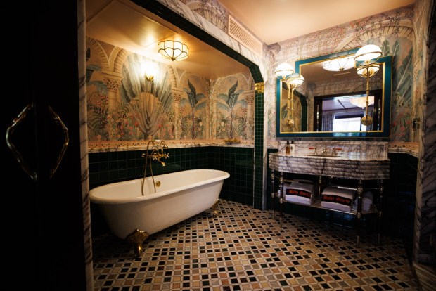 The bathroom of each guest room features mosaic tiling and clawfoot soaking tubs finished with bold wallpaper. (Kristian Carreon / The San Diego Union-Tribune)