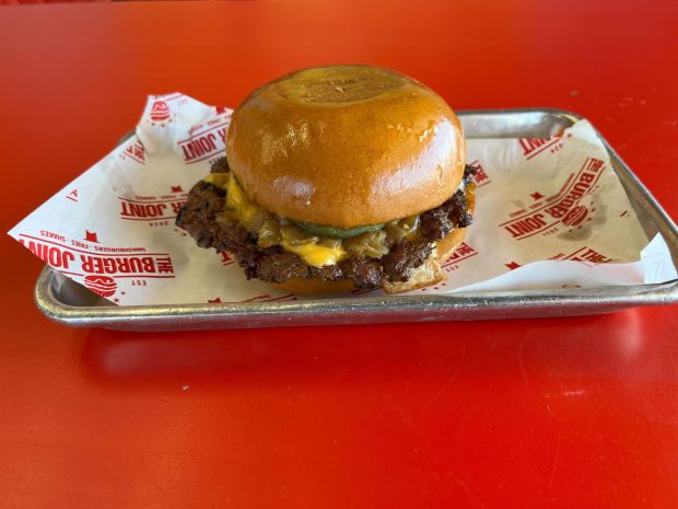 The Joint Burger from The Burger Joint in Miramar is made with a beef patty, caramelized onions, pickles, melted American cheese and joint sauce on a toasted bun. (Abby Hamblin / The San Diego Union-Tribune)